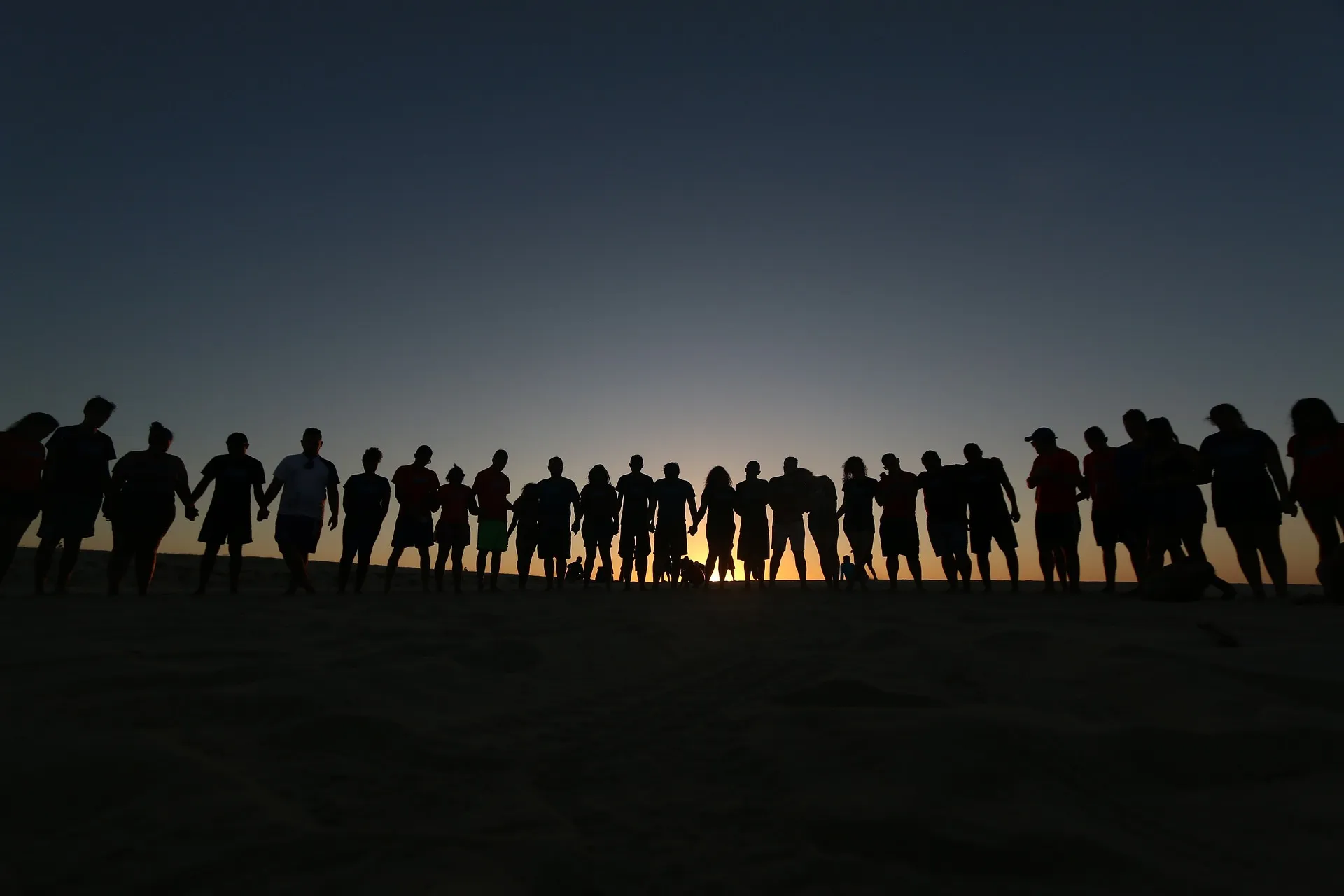 Students standing together at sunset